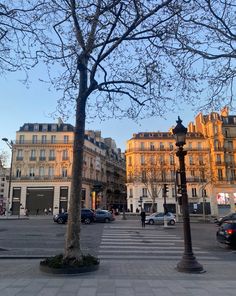 an empty street with cars parked on the side