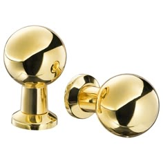 two gold door knobs on a white background