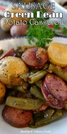 sausage, green bean and potato casserole on a white plate with parsley