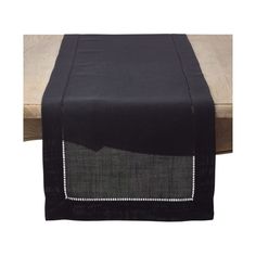 a black table runner with white stitching on the edge and red border around it