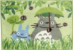 a rug with an image of totoro and hippo holding an umbrella in the grass