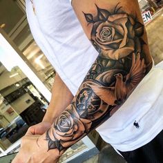 a man with a rose tattoo on his arm