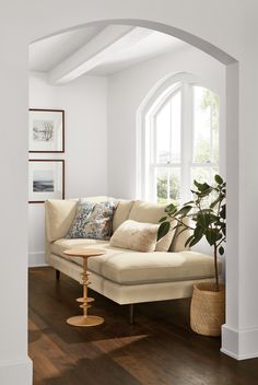 a living room with white walls and wooden floors