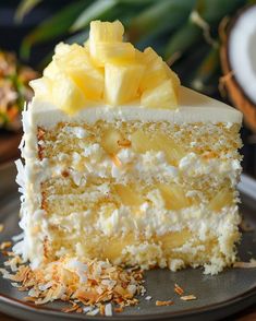 a piece of cake with pineapples on top is sitting on a gray plate