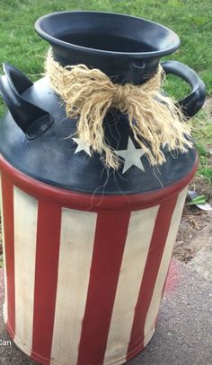 a patriotic trash can with a hat on top