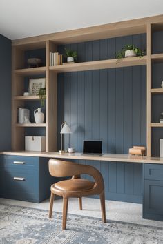 an office with blue walls and wooden shelves