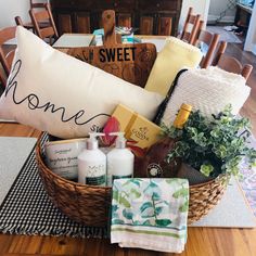 a basket filled with personal care items sitting on top of a wooden table next to a pillow