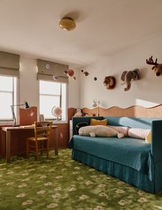 a living room filled with furniture and stuffed animals on the wall