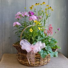 a basket filled with flowers sitting on top of a table