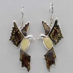 These is a beautiful pair of Sterling Silver Earrings with Baltic Amber. The earrings are made out of solid 925 Silver and there is no nickel or other substances causing most allergies. This makes the earrings hypo allergenic. Size of one Earring in total - with the hook - is  5.0 x 1.9 cm or  1.97 x 0.75 inch Please note: Our jewelry is photographed close up to show detail and may appear larger than they are. We use a dime coin as size reference on one of the pictures. You will receive the item in a gift box - perfect to surprise someone or yourself. Usually we ship on the same day we receive the payment for the order. We want you to be happy with your purchase. If you do not like what you bough can send it back and we will refund you the money. Please do not hesitate to contact us so we Eagle Bird, Amber Earrings, Bird Earrings, Handcrafted Artisan Jewelry, Baltic Amber, Artisan Jewelry, Sterling Silver Earrings, Favorite Jewelry, Jewelry Earrings Dangle