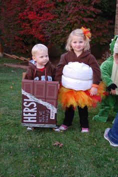 two children dressed up in costumes standing next to each other