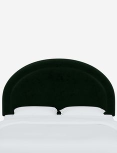 a black headboard on top of a white bed