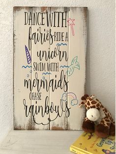 a wooden sign that says dance with fairies's ride a unicorn swim with mermaids chase rainbows