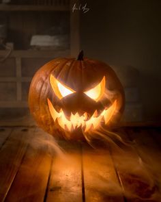 a carved jack o lantern sitting on top of a wooden table