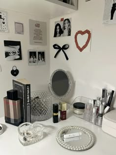 a white desk topped with lots of makeup and personal care items on top of it