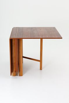 a wooden table sitting on top of a white floor