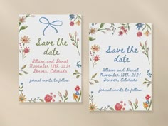 two wedding save the dates cards with flowers and blue ribbon on them, sitting next to each other