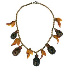 Charming Acorn and leaf charm necklace. Root beer colored carved bakelite acorns with celluloid leaves. Original brass chain.
 Acorns: 1.25" x .75".
 Necklace Length:16" Brass Chain Necklace, Acorn Pendant, Acorn Necklace, Bakelite Jewelry, Art Necklaces, Gold Long Necklace, Vintage Wardrobe, Art Deco Necklace, Sterling Necklaces