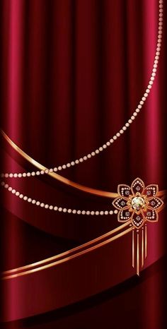 a red curtain with pearls and a gold flower on the end, in front of it