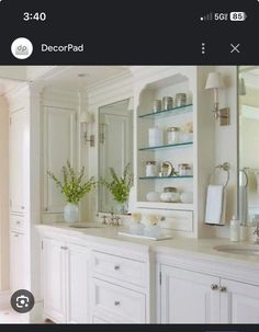 an image of a bathroom setting with white cabinets and marble counter tops on the right side