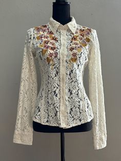 This DB Sports lace button-up blouse brings a Western flair with beautiful embroidery on the front and back. The tapered, fitted style with a rounded bottom hem offers a flattering silhouette, while long sleeves with two-button cuffs complete the look. Perfect for festival or cowgirl chic outfits.Ideal for those seeking Free People boho vibes with a Western twist. Cowgirl Chic Outfits, Chic Fits, Western Blouse, Free People Boho, Boho Cowgirl, Lace Button, Cowgirl Chic, Fitted Style, Cow Girl