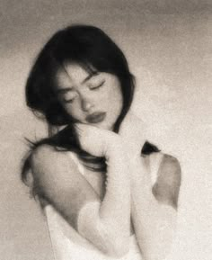 black and white photograph of a woman holding her hand to her face with eyes closed