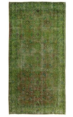 an antique rug with green and brown colors