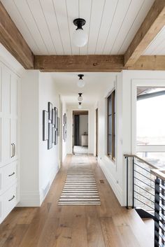 the hallway is clean and ready for guests to use it as an entrance way in this home