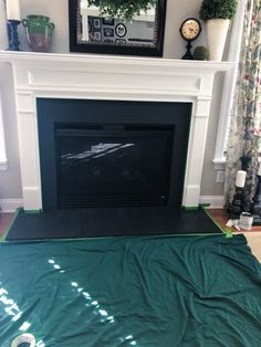 a living room with a fireplace covered in a green tarp next to a mirror