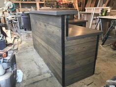 a wooden counter sitting inside of a garage