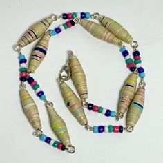 Add Some Vibrancy To Your Outfit With This Handmade Necklace From Fancy Knots. The Necklace Features Multiple Pastel Colors Of Paper Beads And Glass Beads, All Connected By Silver Links. This Beaded Masterpiece Is Perfect For Those Who Love To Experiment With Different Styles And Materials. The Necklace Is A Great Addition To Any Jewelry Collection And Can Be Worn On Any Occasion. With Its Unique Blend Of Colors And Materials, This Necklace Is Sure To Make A Statement. Get Your Hands On This One Fancy Knots, Knots Jewelry, Orange Statement Necklace, Paper Bead Necklace, Paper Beads Necklace, Artisan Jewelry Necklaces, Paper Bead Jewelry, Stone Choker, Handcrafted Artisan Jewelry