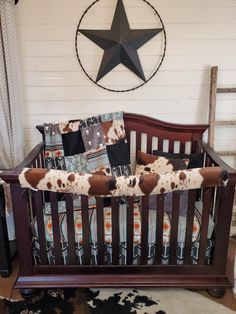 a baby crib with a star on the wall above it