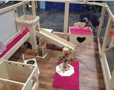 a doll house with furniture and accessories on the floor, including a staircase leading to another room