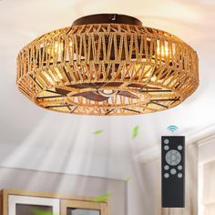 a wicker ceiling light fixture with remote controls on the wall next to it in a living room