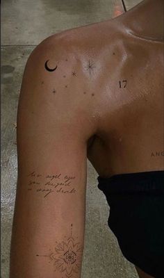 the back of a woman's left arm with a tattoo on it and stars