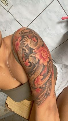 a woman with a dragon tattoo on her arm