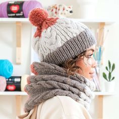 a woman wearing a knitted hat and scarf