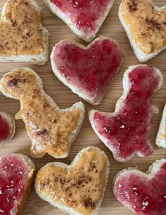 heart shaped cookies with jam on them are arranged in the shape of dogs and hearts