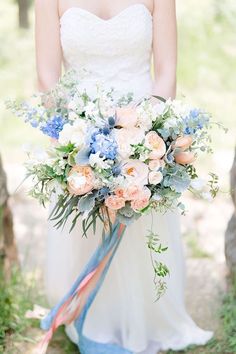 a bride holding a bridal bouquet in her hands