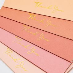 thank you notes are lined up on top of each other with gold writing in different colors