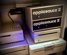 two apple computers sitting on top of each other