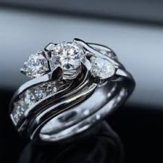 a couple of wedding rings sitting on top of each other