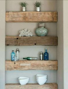 three wooden shelves with vases and other items on them