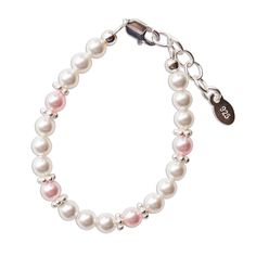 a white bracelet with pink pearls and a silver charm on the clasp, is shown against a white background