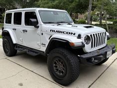 a white jeep parked on the side of a road