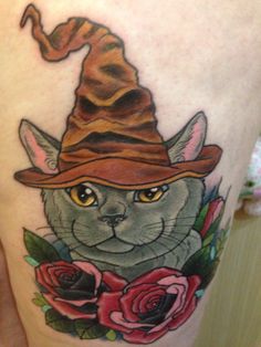 a cat with a hat and roses on its leg