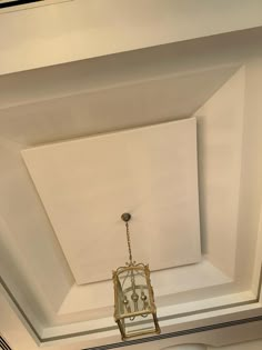 the ceiling is painted white and has a light fixture hanging from it's side