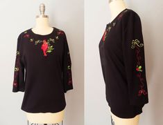 "Vintage Christmas top. Black knit with colorful cardinal and holly embroidery on chest, back and sleeves. Crew neck with 3/4 length sleeves.  Fits like a size medium but please double-check the measurements below to ensure the best fit for you. MEASUREMENTS--Taken with garment laying flat, in inches, doubled: Bust: 42\"  Waist: 44\"  Shoulder: 17\" Sleeves: 17\" Length: 24.5\" Label/ Era: CB Casual / 1990 Fabric: Cotton polyester blend Condition: Great vintage condition. ★ Shop entire shop here: https://www.etsy.com/shop/retrosuzysvintage Instagram | retrosuzysvintage Facebook | retrosuzysvintage" Holly Embroidery, Reindeer Christmas Tree, Ugly Christmas Shirts, Christmas Tops, Bubble Dress, Black Christmas, Reindeer Christmas, Beautiful Hats, Black Knit