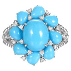 This turquoise ring features 2.95 carats oval turquoise in center, surrounded by 3.16 carats of pear shape turquoise. Assented with 0.15 carat of white round diamonds. All turquoise use in production are from the prominent Sleeping Beauty Mine. Famous for it solid, light blue color with no matrix. Set in 18 karat white gold. A unique present for your loves one. Matching earrings are available, please visit our store-front or send a message to obtain more information. 18 Karat White Gold Oval Turquoise 2.95 carats Pear Turquoise 3.16 carats White Round Brilliance Diamonds 0.15 Carats Diameter Of ring 18.5X17mm Unique Presents, Store Front, Diamond Cluster Ring, Light Blue Color, Diamond Cluster, Cluster Ring, Pear Shape, Matching Earrings, Pear Shaped