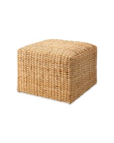 a large square wicker ottoman on a white background